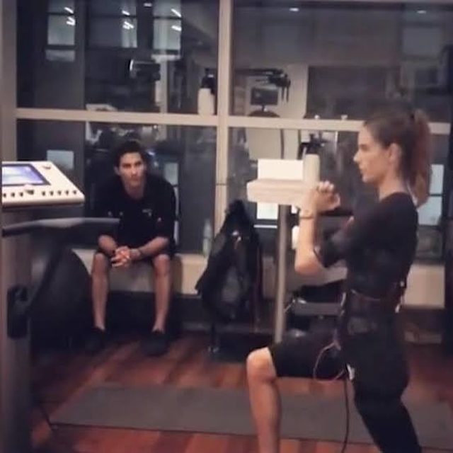 A woman doing a lunge during an EMS training session