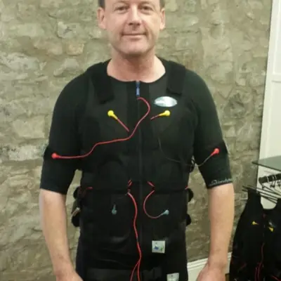 Client wearing the wireless EMS suit before a session