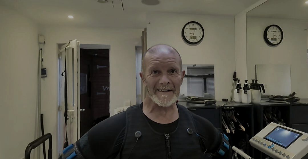 A client in the suit, smiling beside the control unit